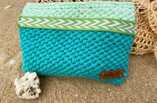 Turquoise zipper pouch on sand